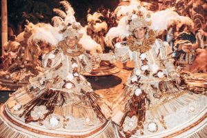 Rio Carnival Dress - A group dressed in Gold, Rustic Red and Cream tones in large brimmed dresses and head dresses