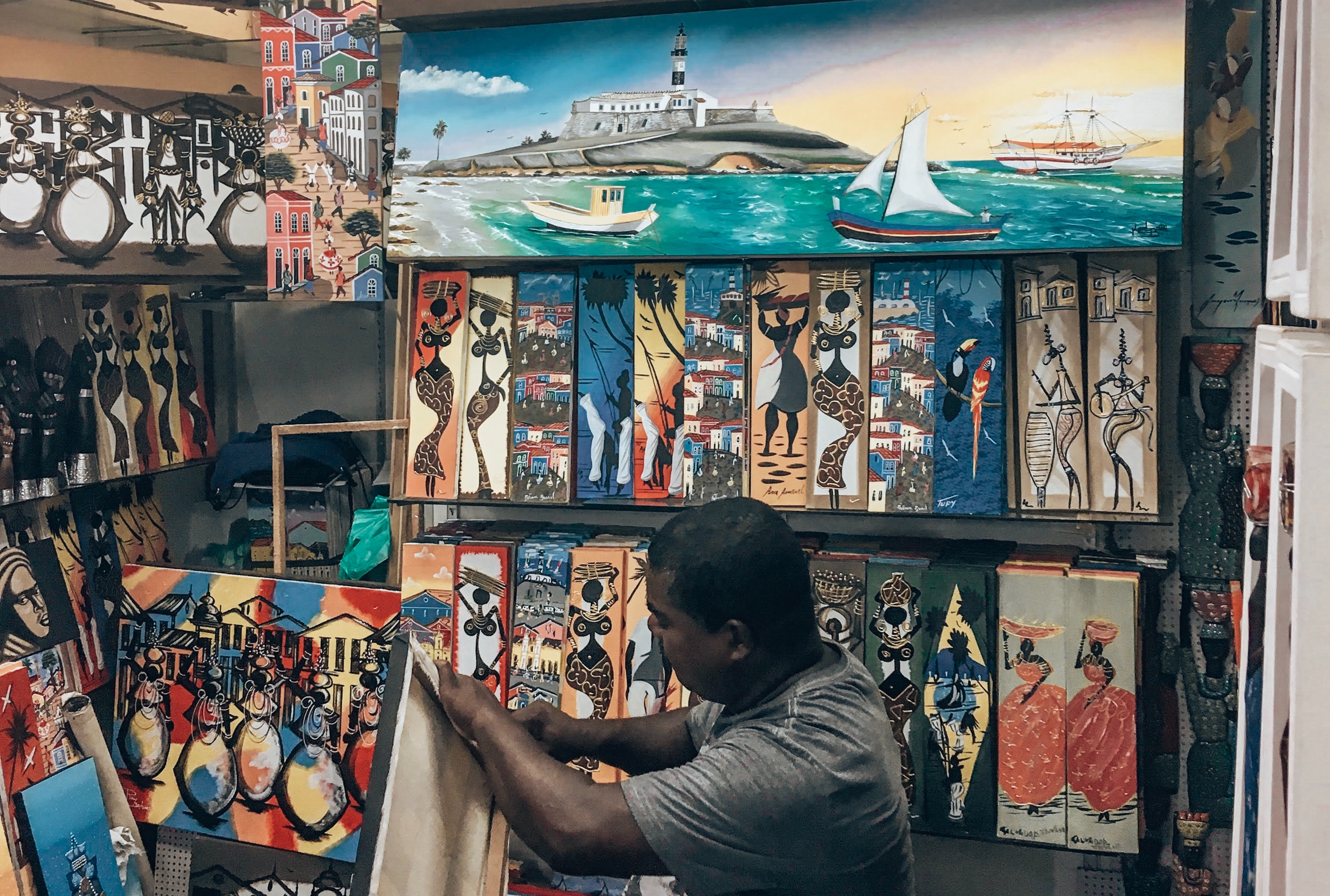 Mercado Modelo Salvador Brazil - Salvador Brazil Market - Indoor market stall selling colourful afro-brazilian art pieces. Things to Do in Salvador Brazil