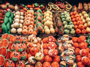 Picture of sweets shaped and painted like fruits and vegetables in a market