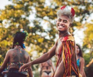 Complete Guide to Rio Carnival - Brazilian Boy Dressed in Carnival Costume with Blonde Afro Hair