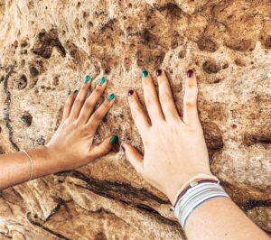 Two hands touching iconic rock formation in Blue Mountains, Sydney