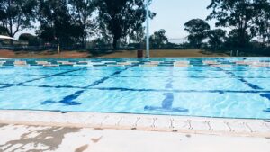 88 days of farm work - Image of people swimming in a public swimming pool