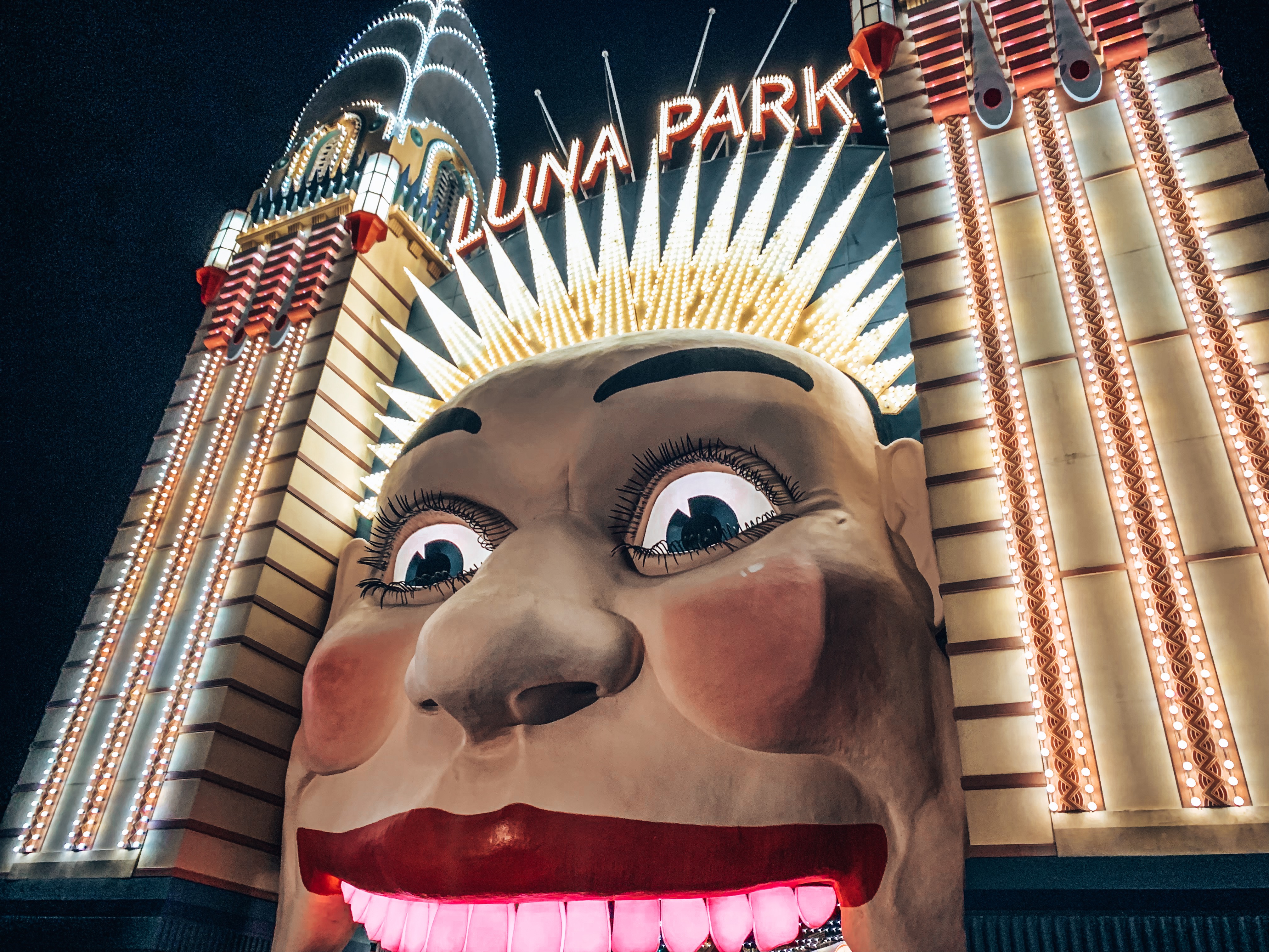 Theme park entrance of a giant smiling face figure with its mouth open as the entrance