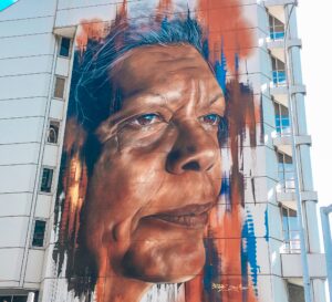 Portrait of an aboriginal woman, Jenny Munro painted onto the side of a large building