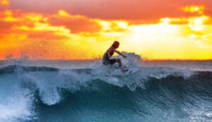 Image of surfer riding a wave - Moving to Australia on WHV