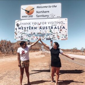 Western Australia border crossing - Two girls posing next to the Western Australia - Northern Territory border sign