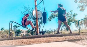 Darwin - Exercise parks. Two girls working out on an outdoor exercise station