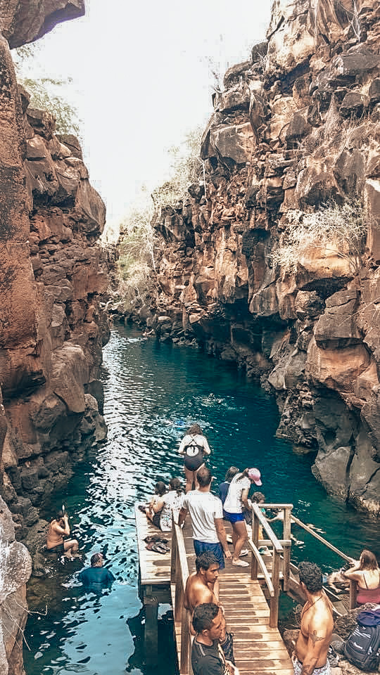 Bright blue watering hole in between two cliff gorges