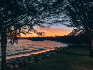East Point Reserve, Darwin. Sunset overlooking a small beach, framed with palm trees