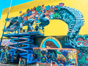 Darwin Street Art Festival - Image of artists painting giant multicoloured crocodile