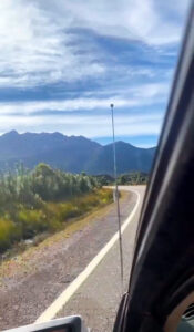 99 bends road Tasmania - Image of mountain range taken from the window of a car -  Lap of Tasmania