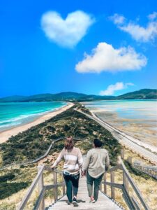 Bruny Island Tasmania - Image of Marlie & Sarah overlooking a long strip of land with two shorelines on either side - Things To Do In Tasmania